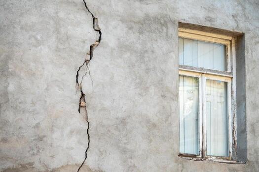 closeup of cracked wall of house destroyed during strong earthquake in turkey photo
